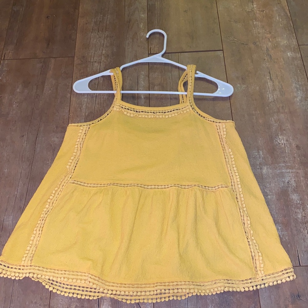 A super cute yellow flowy tank! Detailing is so cute!